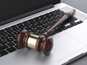 wooden gavel on laptop