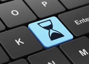 Time concept: Hourglass on computer keyboard background